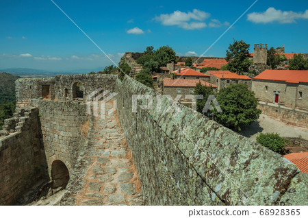 Pathway on stone wall with the front gate of Castle Pathway on stone wall with the front gate of Castle 68928365