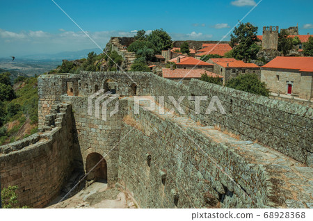 Pathway on stone wall with the front gate of Castle Pathway on stone wall with the front gate of Castle 68928368