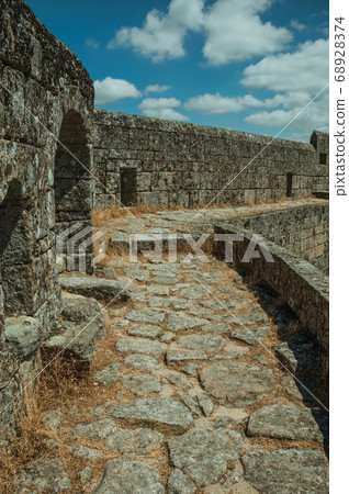 Pathway over thick stone wall in a castle 68928374