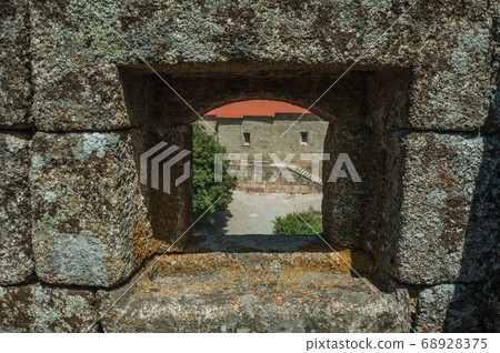 Close-up of arrow slit on stone wall of castle Close-up of arrow slit on stone wall of castle 68928375