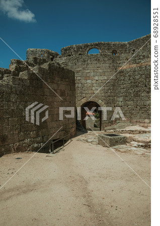 Open gate on stone wall in front the castle 68928551