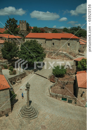 Stone houses and chapel encircling a square 68928556