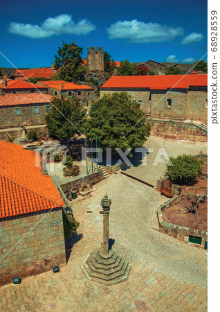 Stone houses and chapel encircling a square Stone houses and chapel encircling a square 68928559