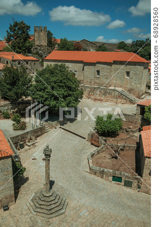 Stone houses and chapel encircling a square 68928560
