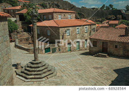 Stone houses and chapel encircling a square Stone houses and chapel encircling a square 68928564