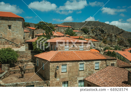 Rooftops of old houses and large wall 68928574