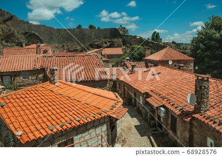 Rooftops of old houses with chimneys 68928576