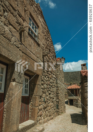 House made of stone with wooden door 68928637