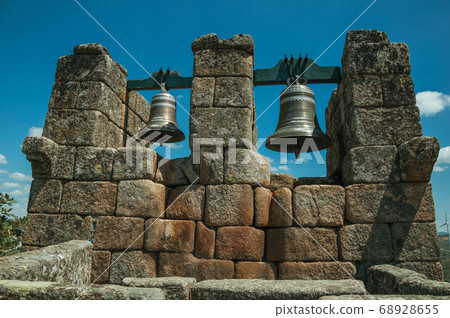 Close-up of bronze bells on top of stone brick Close-up of bronze bells on top of stone brick 68928655