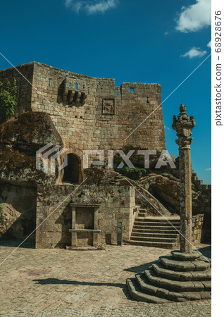 Castle facade over rocky hill on square 68928676
