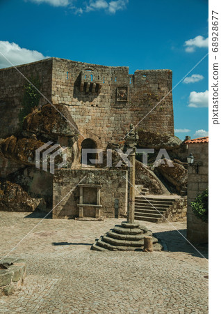 Castle facade over rocky hill on square 68928677