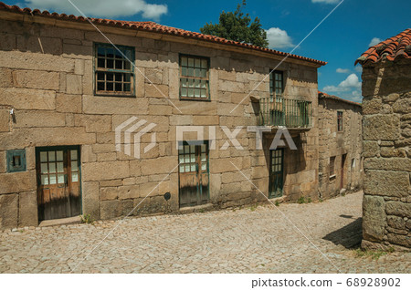 House made of stone on deserted alley 68928902