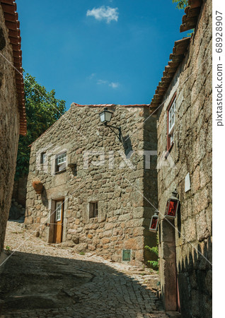 House made of stone with wooden door and deserted alley 68928907