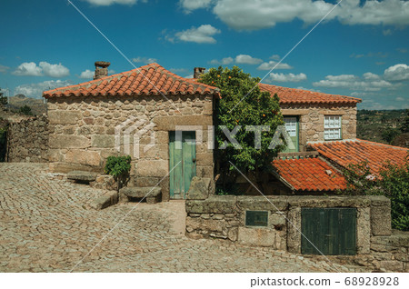 Stone houses with wooden door and deserted alley 68928928