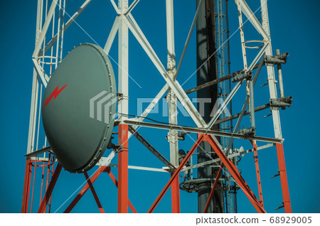 Transmission antenna dish in a tower and blue sky Transmission antenna dish in a tower and blue sky 68929005