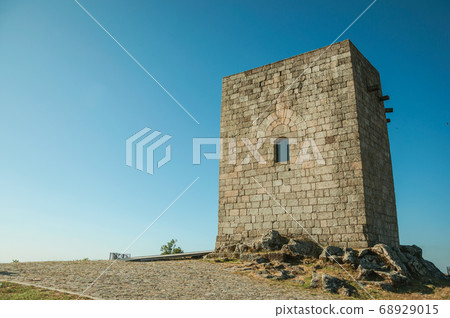 Stone square tower over rocky hill at Guarda 68929015