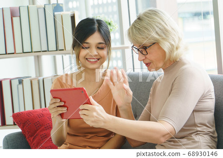 Senior women learn to use technology Senior women learn to use technology 68930146