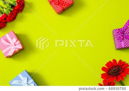 Green background carnation, gerbera and gift box Green background carnation, gerbera and gift box 68930780