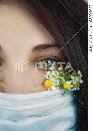 Young attractive woman in floral face mask 68934603
