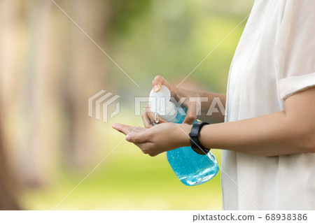 Closeup of hand of asian people using alcohol antiseptic gel to prevent infection of Covid-19 outbreak,woman clean hands with hand sanitizer to avoid contamination with Coronavirus,health care,hygiene 68938386