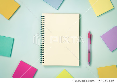 Spiral Notebook and Sticky Note and Pen on Pastel Minimalist Background in Vintage Tone 68939336