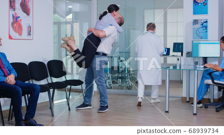 Husband hugging wife after receiving good news 68939734