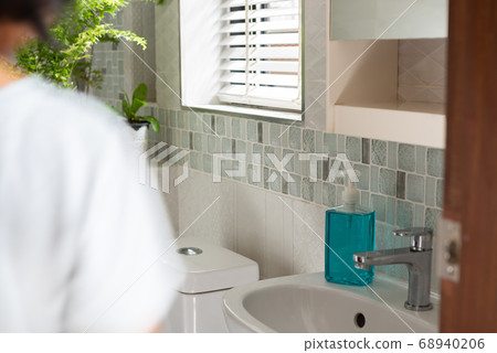 Blurred woman in modern bathroom or restroom Blurred woman in modern bathroom or restroom 68940206