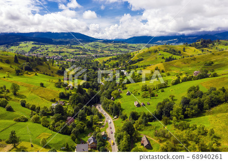 Mountain Village in Carpathians in Summer Season aerial view. Mountain Village in Carpathians in Summer Season aerial view. 68940261