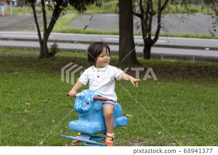 Girl playing with statue spring playground equipment Girl playing with statue spring playground equipment 68941377