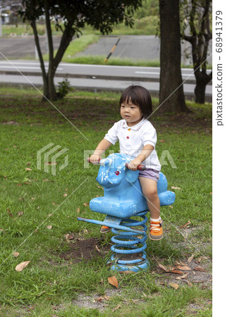 Girl playing with statue spring playground equipment Girl playing with statue spring playground equipment 68941379