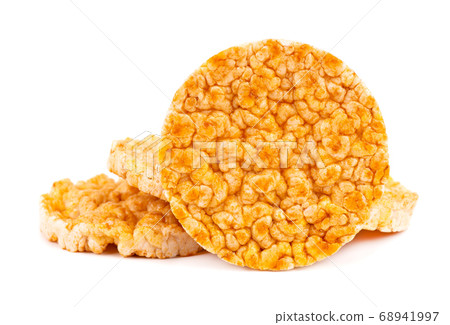 Caramelized rice-corn crispbread, isolated on white background. Sweet puffed whole grain crispbread. Caramelized rice-corn crispbread, isolated on white background. Sweet puffed whole grain crispbread. 68941997
