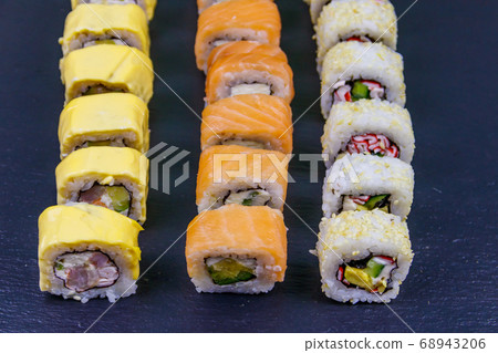 Set of sushi rolls on a black stone slate Set of sushi rolls on a black stone slate 68943206