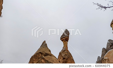 Fairy Chimneys at Pasabag, the valley of the monks in Goreme. Rock Formations with multihead stone mushroom fairy chimneys in Pasabag, Cappadocia, Turkey Fairy Chimneys at Pasabag, the valley of the monks in Goreme. Rock Formations with multihead stone mushroom fairy chimneys in Pasabag, Cappadocia, Turkey 68944075