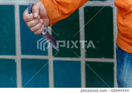 Criminal or bandit hand holding a knife weapon 68944454