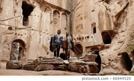 Travel couple alone at ancient Gumusler Monastery surrounded by old stones and ruins in Gumusler, Nigde Travel couple alone at ancient Gumusler Monastery surrounded by old stones and ruins in Gumusler, Nigde 68944520
