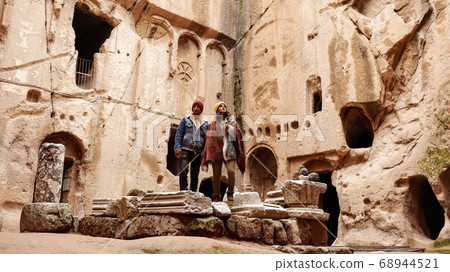 Travel couple alone at ancient Gumusler Monastery surrounded by old stones and ruins in Gumusler, Nigde Travel couple alone at ancient Gumusler Monastery surrounded by old stones and ruins in Gumusler, Nigde 68944521