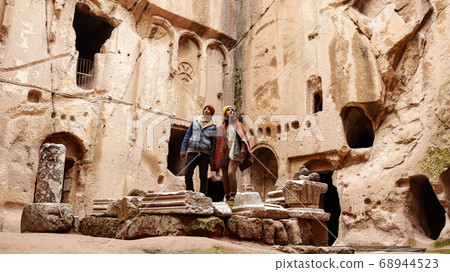 Travel couple alone at ancient Gumusler Monastery surrounded by old stones and ruins in Gumusler, Nigde Travel couple alone at ancient Gumusler Monastery surrounded by old stones and ruins in Gumusler, Nigde 68944523