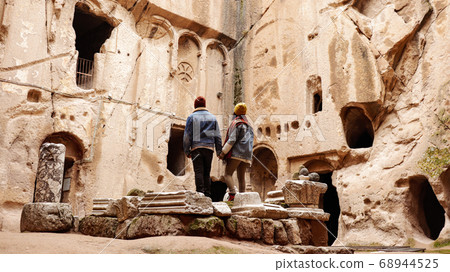 Travel couple alone at ancient Gumusler Monastery surrounded by old stones and ruins in Gumusler, Nigde Travel couple alone at ancient Gumusler Monastery surrounded by old stones and ruins in Gumusler, Nigde 68944525