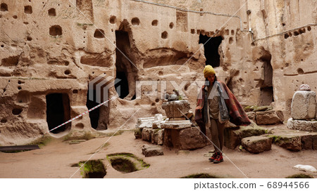 woman alone at ancient Gumusler Monastery surrounded by old stones and ruins in Gumusler, Nigde woman alone at ancient Gumusler Monastery surrounded by old stones and ruins in Gumusler, Nigde 68944566