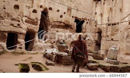 woman alone at ancient Gumusler Monastery surrounded by old stones and ruins in Gumusler, Nigde woman alone at ancient Gumusler Monastery surrounded by old stones and ruins in Gumusler, Nigde 68944567