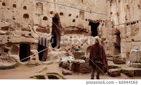 woman alone at ancient Gumusler Monastery surrounded by old stones and ruins in Gumusler, Nigde woman alone at ancient Gumusler Monastery surrounded by old stones and ruins in Gumusler, Nigde 68944568