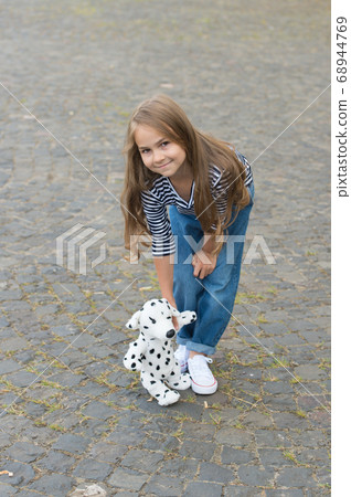 Play is simple joy. Happy baby play with toy dog 68944769