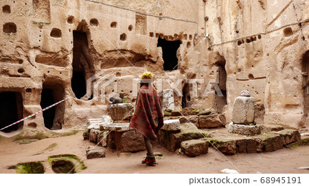 Woman alone at ancient Gumusler Monastery surrounded by old stones and ruins in Gumusler, Nigde Woman alone at ancient Gumusler Monastery surrounded by old stones and ruins in Gumusler, Nigde 68945191