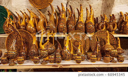 Hittite wine vessels, colorful ceramic vases and porcelain bowls in a underground cave atelier in Avanos in Cappadocia. Turkish traditional ceramic handycrafts in a local pottery shop in Cappadocia 68945345