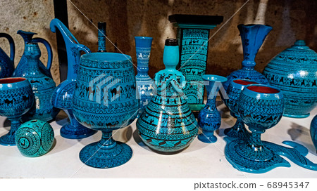 Hittite wine vessels, colorful ceramic vases and porcelain bowls in a underground cave atelier in Avanos in Cappadocia. Turkish traditional ceramic handycrafts in a local pottery shop in Cappadocia 68945347