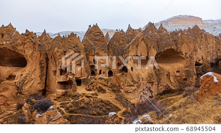Cave houses and monasteries carved into Tufa Rocks at Zelve Open Air Museum (Zelve Valley) in winter season in Cappadocia, Turkey Cave houses and monasteries carved into Tufa Rocks at Zelve Open Air Museum (Zelve Valley) in winter season in Cappadocia, Turkey 68945504