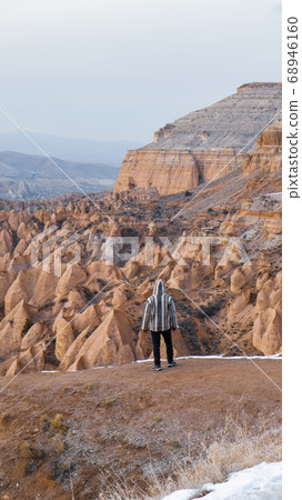 Man watching the volcanic landscape at the valley of love in Goreme, Cappadocia 68946160