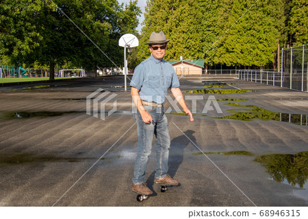 Middle-aged man moving while rowing a free-line skate Vancouver British Columbia Middle-aged man moving while rowing a free-line skate Vancouver British Columbia 68946315
