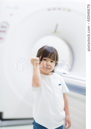 Child undergoing CT examination of medical device Child undergoing CT examination of medical device 68946676