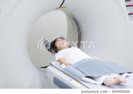 Child undergoing CT examination of medical device Child undergoing CT examination of medical device 68946680